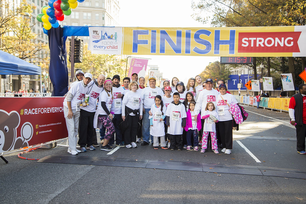 Group of people under banner for the Children's Hospital Race for Every Child in 2015